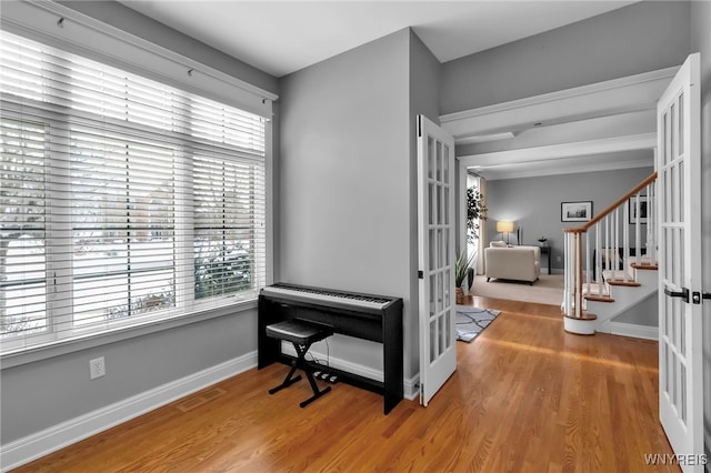 miscellaneous room with hardwood / wood-style flooring and french doors