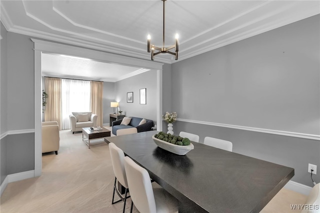 carpeted dining room featuring an inviting chandelier and crown molding