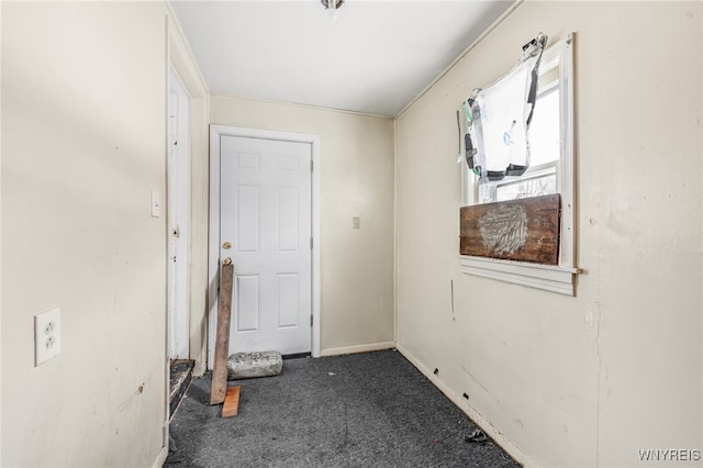 entryway featuring dark carpet