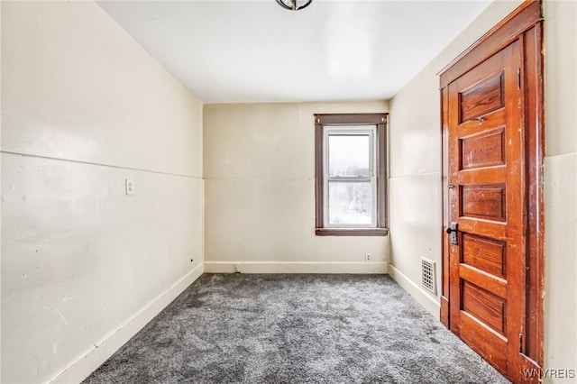 unfurnished room with dark carpet