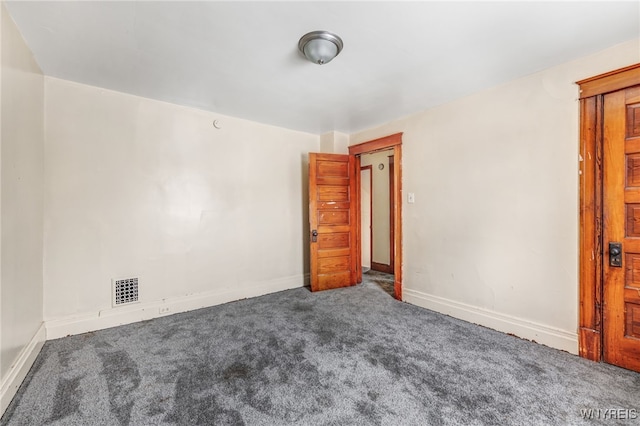 empty room with dark colored carpet