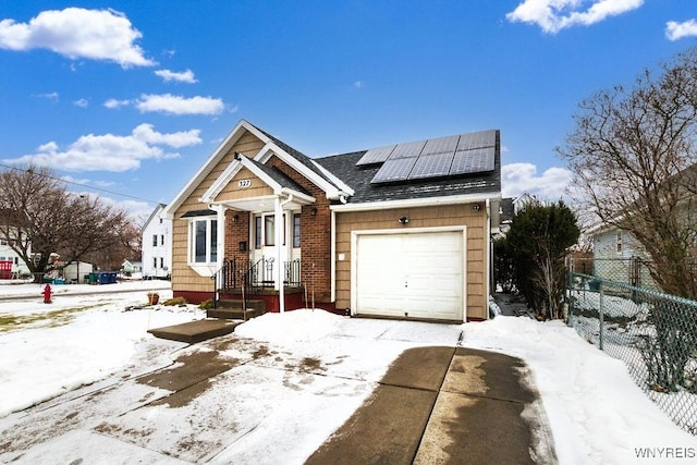 view of front of house with a garage and solar panels