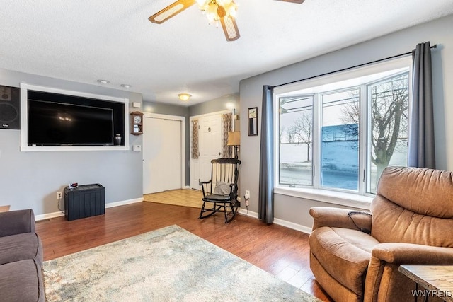 living room featuring hardwood / wood-style floors and ceiling fan