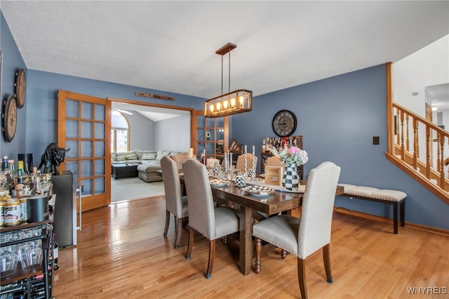 dining area featuring light wood-type flooring and french doors