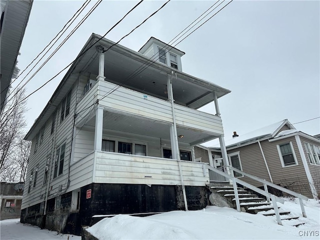 view of front facade with a balcony and covered porch