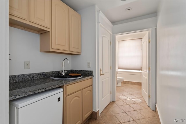 1208 James St, Syracuse, NY 13203 - kitchen with dishwasher, sink, and dark stone countertops