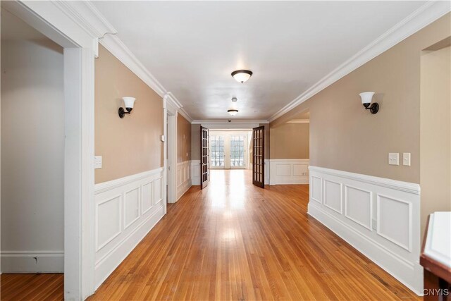 1208 James St, Syracuse, NY 13203 - corridor featuring ornamental molding, french doors, and light wood-type flooring