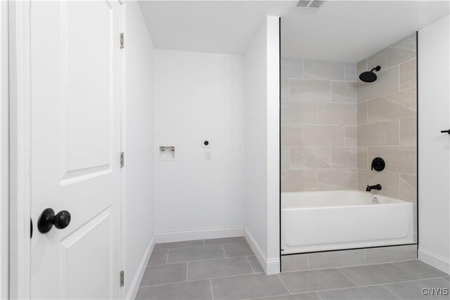 1208 James St, Syracuse, NY 13203 - bathroom with tiled shower / bath combo and tile patterned floors