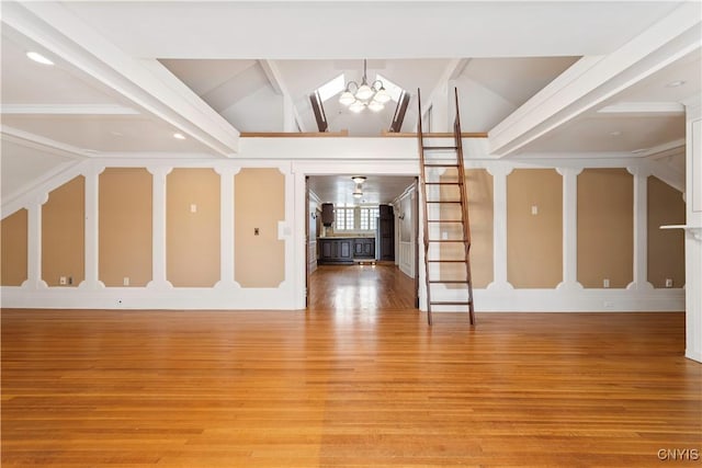 1208 James St, Syracuse, NY 13203 - unfurnished living room featuring wood-type flooring, lofted ceiling with beams, and a notable chandelier