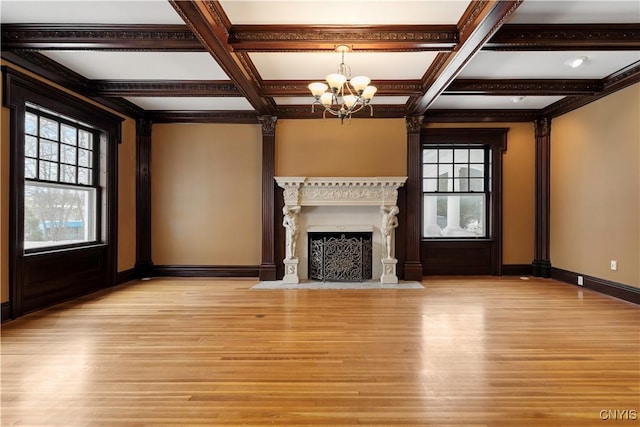 1208 James St, Syracuse, NY 13203 - unfurnished living room with a healthy amount of sunlight, coffered ceiling, and light hardwood / wood-style flooring