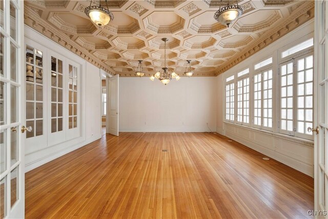 1208 James St, Syracuse, NY 13203 - unfurnished dining area with a notable chandelier and wood-type flooring