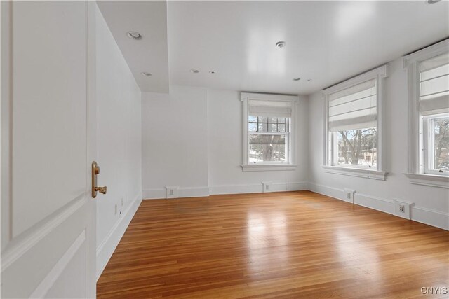 1208 James St, Syracuse, NY 13203 - spare room with light hardwood / wood-style flooring and a healthy amount of sunlight
