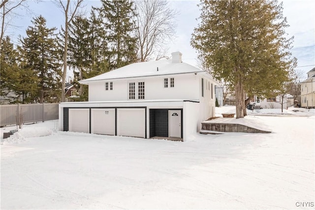 1208 James St, Syracuse, NY 13203 - snow covered rear of property with a garage
