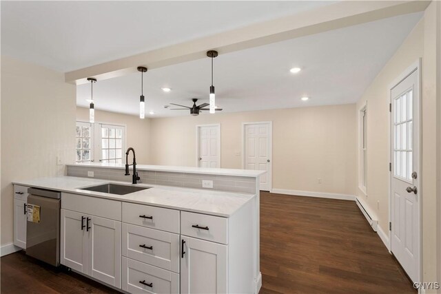1208 James St, Syracuse, NY 13203 - kitchen featuring decorative light fixtures, stainless steel dishwasher, kitchen peninsula, and baseboard heating