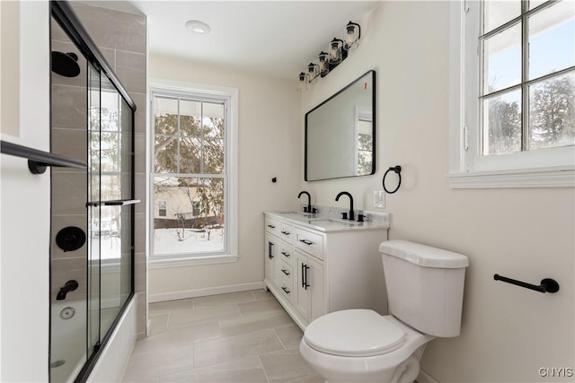1208 James St, Syracuse, NY 13203 - full bathroom featuring vanity, shower / bath combination with glass door, and toilet