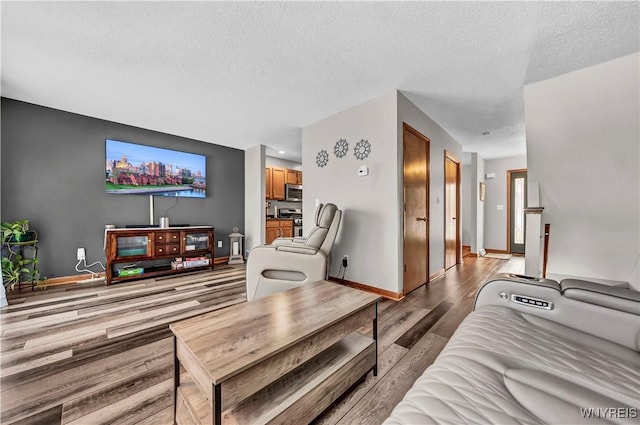 living room featuring light hardwood / wood-style floors and a textured ceiling