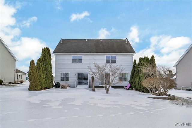 view of snow covered rear of property