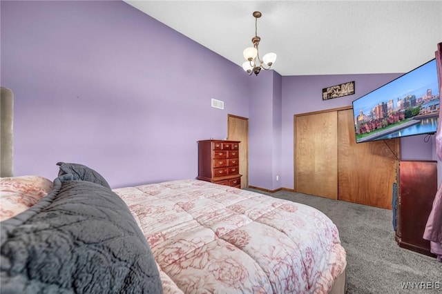 bedroom with vaulted ceiling, light carpet, a notable chandelier, and a closet