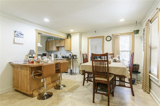 kitchen featuring crown molding, a breakfast bar area, and kitchen peninsula