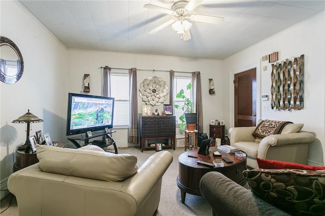 living room with ornamental molding, light carpet, and ceiling fan