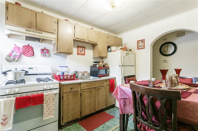 kitchen with white appliances, ornamental molding, and sink