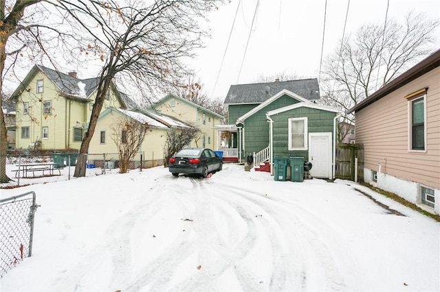 view of snow covered rear of property