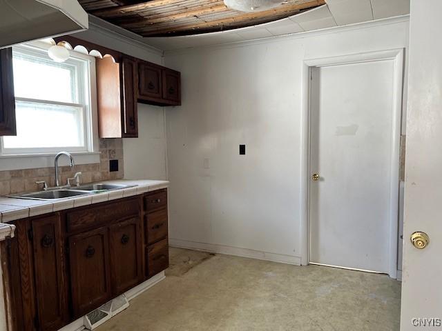 kitchen featuring visible vents, decorative backsplash, tile counters, wooden ceiling, and a sink