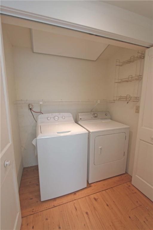 washroom featuring independent washer and dryer and light wood-type flooring