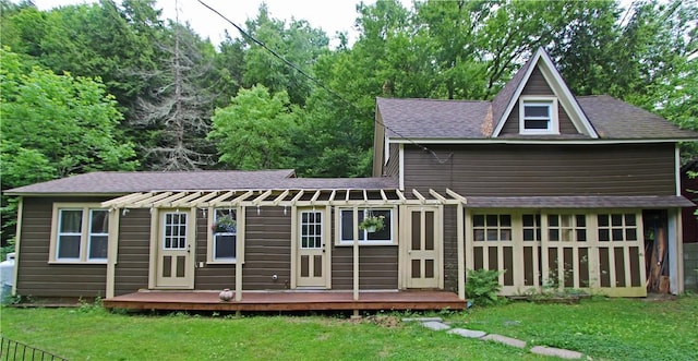 back of property with a yard and an outdoor structure