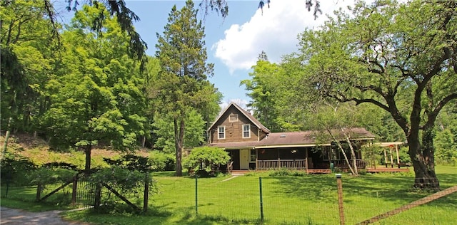 back of property with a porch and a lawn