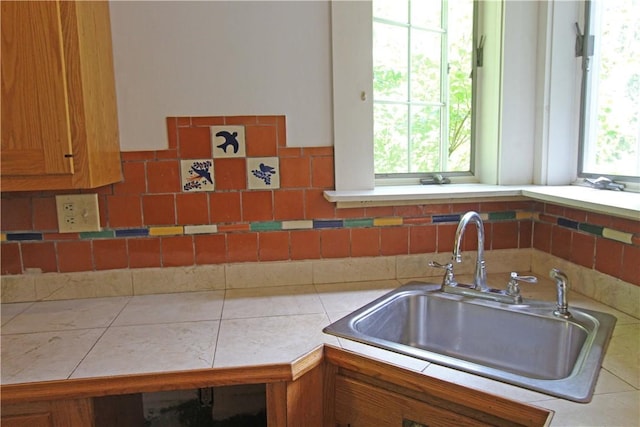 kitchen featuring tile counters and sink