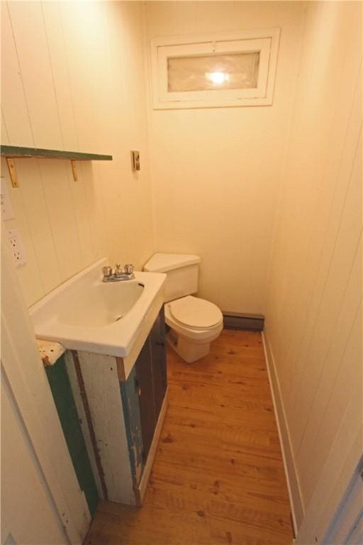 bathroom featuring hardwood / wood-style flooring, vanity, and toilet