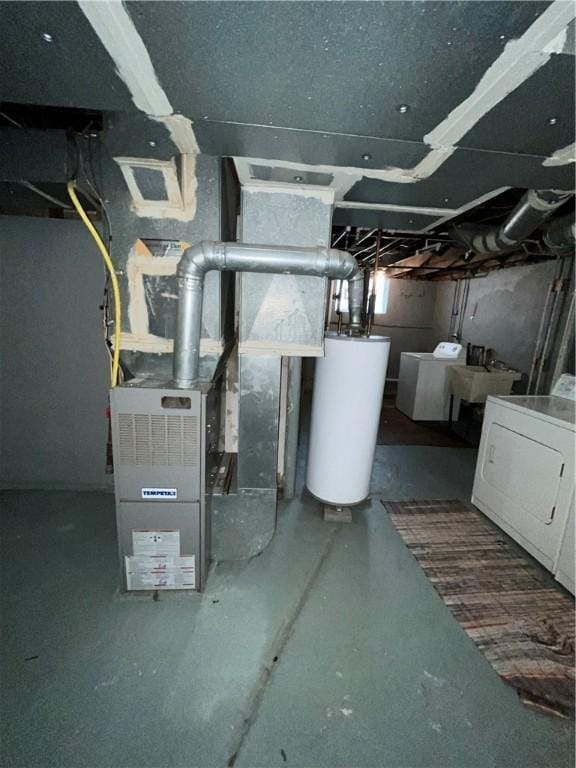 utilities featuring water heater and washer and clothes dryer