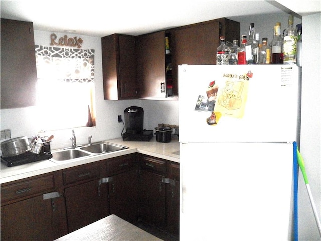 6024 W Willow Pt, Canadice, NY 14471 - kitchen with freestanding refrigerator, a sink, dark brown cabinets, and light countertops