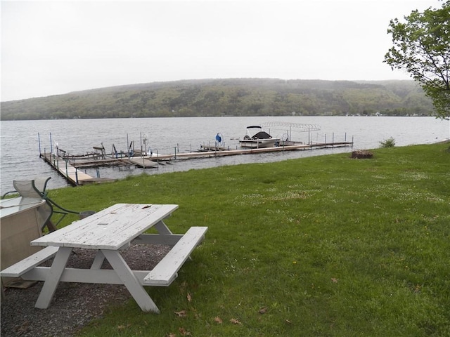 6024 W Willow Pt, Canadice, NY 14471 - dock area featuring a water view, boat lift, a lawn, and a view of trees