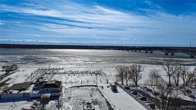 snowy aerial view with a water view