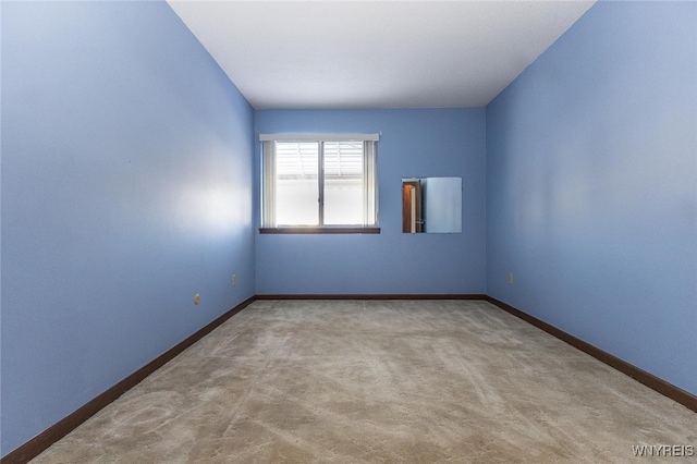 unfurnished room with light colored carpet