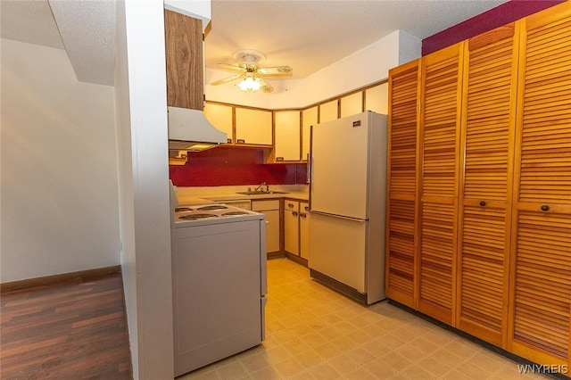 kitchen with ceiling fan, sink, and white appliances