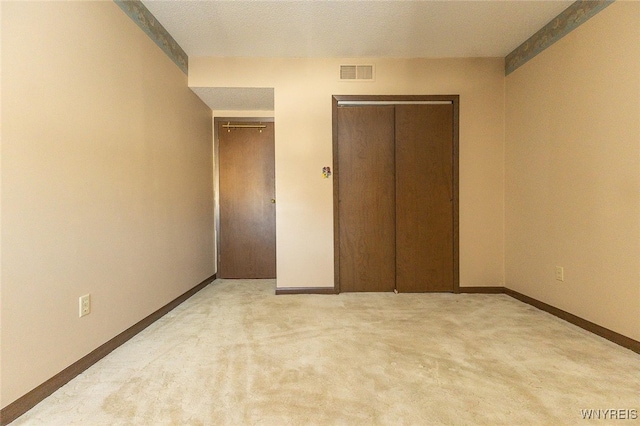 unfurnished bedroom featuring light carpet