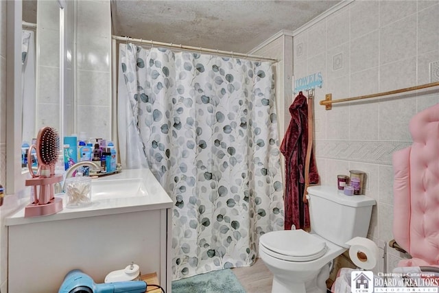 bathroom with tile walls, vanity, a shower with curtain, and toilet