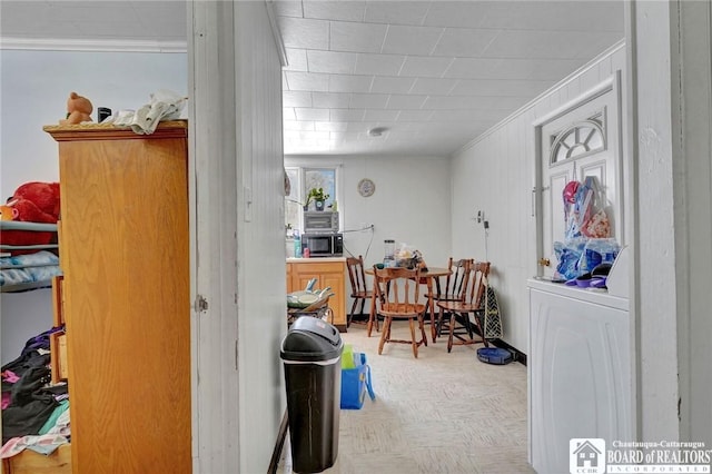 interior space with ornamental molding and light parquet floors