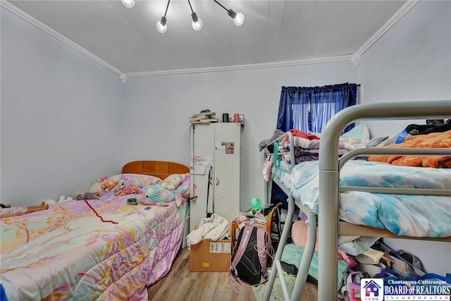 bedroom featuring ornamental molding and hardwood / wood-style floors