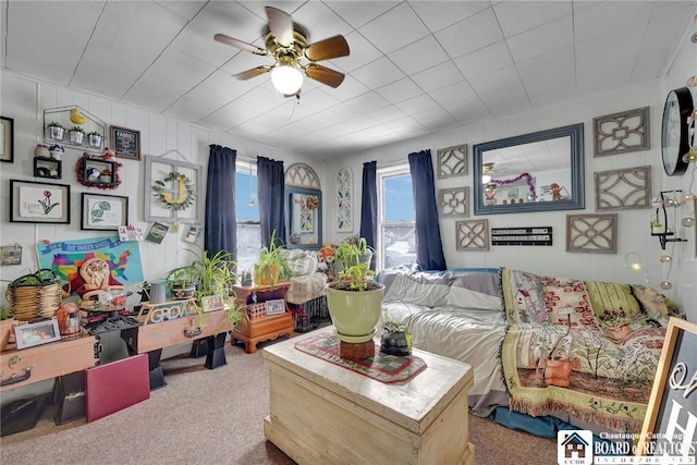 living room featuring ceiling fan and carpet