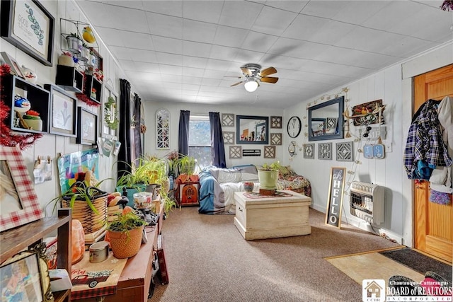 interior space with heating unit, ceiling fan, and carpet flooring