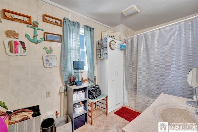 bathroom with vanity, curtained shower, and tile patterned floors