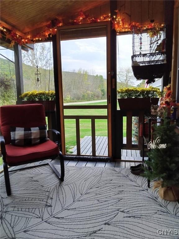 sunroom featuring lofted ceiling