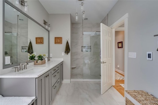 bathroom featuring vanity and a shower with shower door