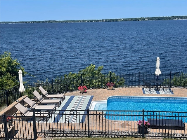 view of swimming pool featuring a water view and a patio area