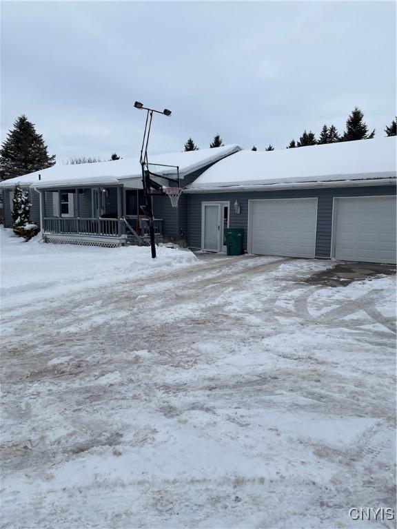 view of front of home with a porch and a garage