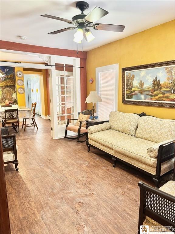 living room featuring hardwood / wood-style flooring and ceiling fan